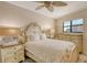 Spacious bedroom featuring ornate bed frame, matching nightstands, and a window at 5740 Midnight Pass Rd # 307, Sarasota, FL 34242