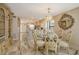 Elegant dining room with marble floors, decorative mirror, and view of a beautifully remodeled kitchen at 5740 Midnight Pass Rd # 307, Sarasota, FL 34242