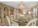 Sophisticated dining area with a decorative glass table and built-in bookcase at 5740 Midnight Pass Rd # 307, Sarasota, FL 34242