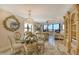 Elegant dining area with a chandelier and built-in shelving at 5740 Midnight Pass Rd # 307, Sarasota, FL 34242