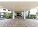 Welcoming entrance to the building with manicured landscaping at 5740 Midnight Pass Rd # 307, Sarasota, FL 34242