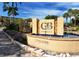 Beautiful Gulf & Bay Club entrance with lush landscaping, palms, and flowing fountain at 5740 Midnight Pass Rd # 307, Sarasota, FL 34242