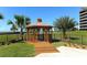 A beautiful wooden gazebo with a wood path in a landscaped garden, with views of a condominium at 5740 Midnight Pass Rd # 307, Sarasota, FL 34242