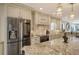 Contemporary kitchen featuring custom cabinetry, stainless steel appliances, and a granite island at 5740 Midnight Pass Rd # 307, Sarasota, FL 34242