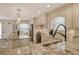 Open kitchen with granite countertops, stainless appliances, and modern lighting at 5740 Midnight Pass Rd # 307, Sarasota, FL 34242