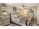 Relaxing main bedroom with a decorative mirror, dresser, and a glimpse into the main bath at 5740 Midnight Pass Rd # 307, Sarasota, FL 34242