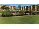 Scenic view of the community pond with lush landscaping and tiki huts for shade at 5740 Midnight Pass Rd # 307, Sarasota, FL 34242