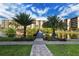 Beautiful community pond with a walking path and fountain at Gulf & Bay Club at 5740 Midnight Pass Rd # 307, Sarasota, FL 34242