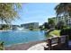 Serene waterfront view of the pond with the condominium complex building in the background at 5740 Midnight Pass Rd # 307, Sarasota, FL 34242