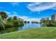 Scenic pond surrounded by lush greenery with a central fountain, creating a serene environment at 5740 Midnight Pass Rd # 307, Sarasota, FL 34242