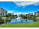 Beautiful tropical pond with fountain, pedestrian bridge, and lush landscaping in a serene community setting at 5740 Midnight Pass Rd # 307, Sarasota, FL 34242