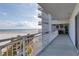 Expansive balcony overlooking the beach featuring white railings and ample space for outdoor relaxation at 5830 Midnight Pass Rd # 502, Sarasota, FL 34242
