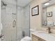 Modern bathroom with a glass-enclosed shower and marble-style tile at 5830 Midnight Pass Rd # 502, Sarasota, FL 34242