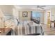 Bright bedroom features a king-size bed, balcony access and an ensuite bathroom at 5830 Midnight Pass Rd # 502, Sarasota, FL 34242