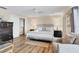 This bedroom features neutral decor, wood floors and a large closet at 5830 Midnight Pass Rd # 502, Sarasota, FL 34242