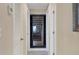 Hallway features a glass enclosed wine cellar, bright lighting, and tile flooring at 5830 Midnight Pass Rd # 502, Sarasota, FL 34242