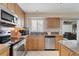 Bright kitchen featuring stainless steel appliances, granite countertops, and a view to the dining area at 5830 Midnight Pass Rd # 502, Sarasota, FL 34242