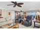 Open living area features tile floors, ceiling fans, seating and a large window with ocean views at 5830 Midnight Pass Rd # 502, Sarasota, FL 34242