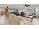 Open-concept living area features tile floors, ceiling fans and a large window with views of the ocean at 5830 Midnight Pass Rd # 502, Sarasota, FL 34242