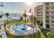 Aerial view of the kidney-shaped community pool with ample lounge chairs and beach access at 5830 Midnight Pass Rd # 502, Sarasota, FL 34242