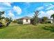 Grassy backyard enclosed with a black metal fence, lush greenery and a screened-in lanai at 6630 Horned Owl Pl, Sarasota, FL 34241