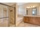 Primary bathroom featuring a glass shower enclosure, soaker tub and dual sink vanity at 6630 Horned Owl Pl, Sarasota, FL 34241