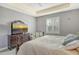 Comfortable bedroom with neutral walls, soft carpet, plantation shutters, and natural light at 6630 Horned Owl Pl, Sarasota, FL 34241