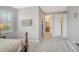 Spacious bedroom with soft carpet, neutral walls, and an ensuite bathroom and walk in closet at 6630 Horned Owl Pl, Sarasota, FL 34241