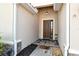 Charming front entrance with stone accents, decorative door, and welcoming 'hello' mat at 6630 Horned Owl Pl, Sarasota, FL 34241