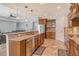 Charming kitchen featuring granite countertops, stainless steel appliances, and warm wood cabinetry at 6630 Horned Owl Pl, Sarasota, FL 34241