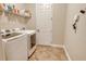 Laundry room with tile floors, shelving with supplies, and washer and dryer at 6630 Horned Owl Pl, Sarasota, FL 34241
