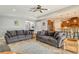 Inviting living room with two sofas, neutral decor, and an open layout connected to the kitchen at 6630 Horned Owl Pl, Sarasota, FL 34241