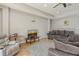 Comfortable living room featuring modern furnishings, a ceiling fan, and a cozy atmosphere at 6630 Horned Owl Pl, Sarasota, FL 34241