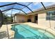 Beautiful kidney-shaped pool in screened lanai with ample space for outdoor lounging and entertaining at 6630 Horned Owl Pl, Sarasota, FL 34241