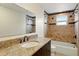 Bathroom featuring granite countertop vanity, tub, and patterned tile shower at 1741 Font Ln, Holiday, FL 34691