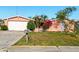 Inviting single-Gathering home showcasing a well-manicured lawn and established greenery at 1741 Font Ln, Holiday, FL 34691