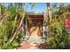 Inviting front entryway with double doors, lush landscaping, and stone walkway at 1741 Font Ln, Holiday, FL 34691