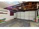 Spacious garage with exposed ceiling, offering ample storage and workspace for projects and vehicles at 1741 Font Ln, Holiday, FL 34691