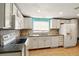 Updated kitchen with white cabinets, granite countertops, and modern appliances at 1741 Font Ln, Holiday, FL 34691