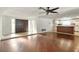 Open-concept living space showing wood floors, kitchen access, and a large entryway at 1741 Font Ln, Holiday, FL 34691