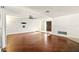 Spacious living room featuring hardwood floors, a ceiling fan, and lots of natural light at 1741 Font Ln, Holiday, FL 34691