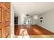 Bright living room with hardwood floors and a stone fireplace at 1741 Font Ln, Holiday, FL 34691