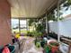 Enclosed porch filled with plants and outdoor scenery at 1741 Font Ln, Holiday, FL 34691