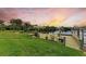 Backyard with a spacious wooden dock and boat lift at sunset at 17413 Pheasant Cir, Port Charlotte, FL 33948