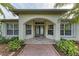 Arched doorway of home featuring a glass door and ample light at 17413 Pheasant Cir, Port Charlotte, FL 33948