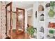 Inviting entryway with brick accent wall, glass paneled doors, and stylish shelving at 3060 Grand Bay Blvd # 175, Longboat Key, FL 34228