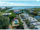 Scenic aerial view of waterfront property with a community pool and lush landscaping at 3805 E Bay Dr # 302, Holmes Beach, FL 34217