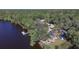 Aerial view of a riverfront property with a two-story home, a private dock, and kayak storage at 3826 E 155Th E Ave, Parrish, FL 34219