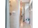 Tiled shower next to a hallway with a linen basket and bedroom visible at 3826 E 155Th E Ave, Parrish, FL 34219