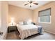 Cozy bedroom with a queen bed, ceiling fan, and window with blinds at 3826 E 155Th E Ave, Parrish, FL 34219